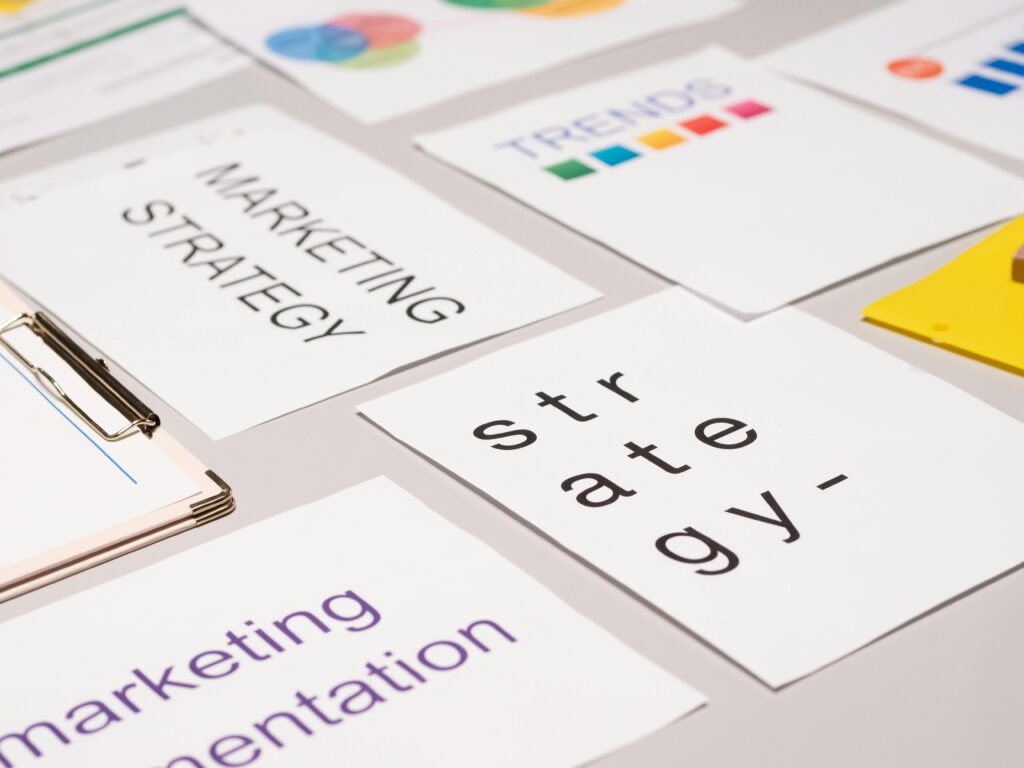 A top view of marketing strategy documents and graphs arranged on a desk, showcasing business planning.